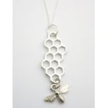 HONEYCOMB AND BEE PENDANT BY BOTANIC ISLES the silver plated honeycomb pendant with bee charm