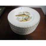 TWELVE FRENCH PORCELAIN PLATES the white ground with painted panels depicting fish 24cm diameter