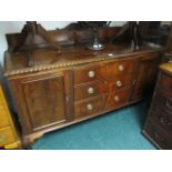 A CHIPPENDALE STYLE MAHOGANY SIDEBOARD the rectangular top with gadrooned rim above three frieze