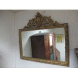 A GILT RECTANGULAR MIRROR with scroll surmount and moulded surround 85cm x 90cm