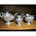A THREE PIECE VICTORIAN PLATED  EMBOSSED TEA SET