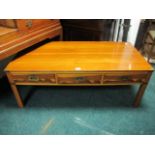 A YEW WOOD COFFEE TABLE the rectangular top with frieze drawers and brass sunken handles on moulded