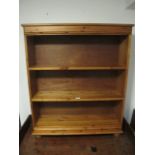 A PINE THREE TIER OPEN FRONT BOOKCASE on bun feet 102cm (h) x 86cm (w) x 22cm (d)