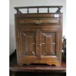 A LATE VICTORIAN MAHOGANY HANGING CUPBOARD with Gothic panelled doors