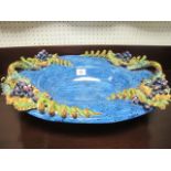 A SPANISH MAJOLICA OVAL DISH with grape decoration 15cm (h) x 51cm (w) x 41cm (d)