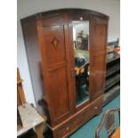 AN EDWARDIAN MAHOGANY INLAID WARDROBE with mirrored door the base containing a drawer