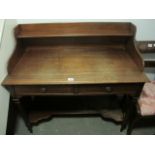 AN EDWARDIAN MAHOGANY SIDE TABLE the super structure with moulded shelf above two frieze drawers on