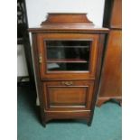 AN EDWARDIAN MAHOGANY AND SATINWOOD CROSS BANDED MUSIC CABINET with glazed door and hinged