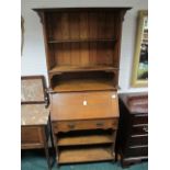 AN ARTS AND CRAFTS OAK BUREAU BOOKCASE the super structure with three open shelves above a hinged