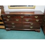 A MAHOGANY LOWBOY containing seven long drawers with brass drop handles on ogee bracket feet 87cm