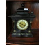 A BLACK PAINTED MANTLE CLOCK in classical form with simulated marble columns white enamel dial and