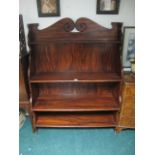 A SIMULATED ROSEWOOD BOOKCASE with four open shelves on standard end supports 154cm (h) x 123cm (w)