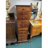 A HARDWOOD TALLBOY containing ten long drawers on bracket feet 134cm (h) x 41cm (w) x 47cm (d)