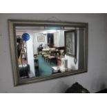 A RECTANGULAR MIRROR with applied decoration and gilt frame 52cm x 56cm