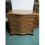 A GEORGIAN STYLE WALNUT CHEST of serpentine outline the shaped top with brushing slide above four