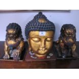 A GILT PLASTER MODEL of a sphinx head together with a pair of stylized lions