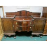 A CHIPPENDALE STYLE MAHOGANY SIDEBOARD of rectangular bowed outline with two frieze drawers and