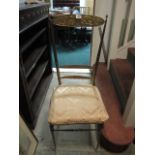 A BRASS FRAMED CHAIR with upholstered seat on cylindrical tapering legs