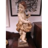 A PAIR OF WOODEN WHITE PAINTED AND GILDED CLASSICAL FIGURES modelled as children standing on a