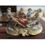 A LARGE PAINTED PORCELAIN GROUP Italian 20th Century depicting young boys in a card game seated on