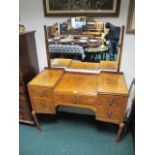 AN EARLY 20TH CENTURY BURR WALNUT DRESSING TABLE in Queen Anne style the shaped mirrored back above