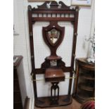 AN EARLY 20TH CENTURY MAHOGANY HALL STAND rectangular open back headed by a broken arched pediment