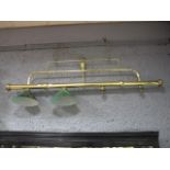 A TUBULAR BRASS SNOOKER TABLE LIGHT fitted with green glass and white enamelled shades (2 missing)