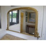 A GOLD PAINTED OVAL MANTEL MIRROR the moulded frame with rounded corners foliate corner mounts