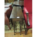 A 19TH CENTURY MOHOGANY DROPPED LEAF TABLE rectangular top raised on spindle turned supports with