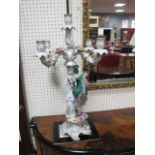 A PAIR OF PAINTED PORCELAIN CONTINENTAL STYLE FIVE BRANCH CANDELABRA decorated with flowerheads and