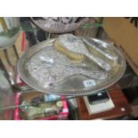 A THREE PIECE SILVER BACK DRESSING TABLE SET together with an oval plated tray