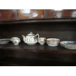 A ORIENTAL STYLE PORCELAIN TEA SET the with a white ground with gilded and red borders decorated