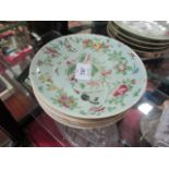 A SET OF 4 ORIENTAL PLATES the light green ground decorated with flower heads foliage and