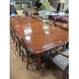 A LARGE MAHOGANY EXTENDING DINING ROOM TABLE the rectangular top moulded rim rounded corners raised