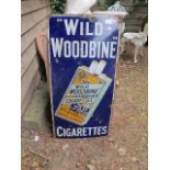 AN EARLY 20TH CENTURY METAL ENAMELED ADVERTISING SIGN (wild woodbine cigarettes) 92cm