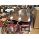 AN EARLY 19TH CENTURY MAHOGANY EXTENDING DINING ROOM TABLE the rectangular top with rounded ends