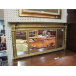 A RECTANGULAR GILT OVERMANTEL MIRROR the moulded frame fitted with classical columns above the