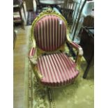 A PAIR OF CONTINENTAL STYLE GILT UPHOLSTERED ARM CHAIRS the moulded frames decorated with foliate