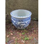 AN ORIENTAL STYLE GLAZED PORCELAIN JARDINIERE the white ground decorated with blue foliates and