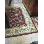 A GOOD CREAM AND MAROON RUG the central medallion with scroll and leaf decoration within a three