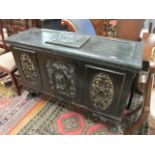 A CONTINENTAL STYLE CARVED WOOD AND BLACK PAINTED COFFER 19TH CENTURY of rectangular form the