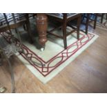 A PAIR OF MODERN WOOL RUGS the cream ground decorated with a red geometric style border each 180cm