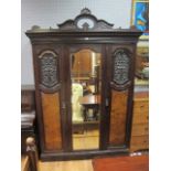 AN EDWARDIAN MAHOGANY AND BURR WALNUT VENEERED THREE DOOR WARDROBE the broken raised pediment