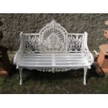 A VICTORIAN STYLE WHITE PAINTED CAST IRON GARDEN BENCH the open work back centred by an arched