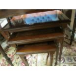 A GEORGIAN STYLE MAHOGANY NEST OF TABLES the rectangular top with burr walnut veneered panel molded