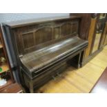 A 20TH CENTURY MAHOGANY FRAMED UPRIGHT PIANO the panelled back headed by a hexagonal carved border