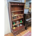 A MAHOGANY OPEN FRONT BOOKCASE the outset moulded cornice above three adjustable shelves the base