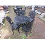 A VICTORIAN STYLE FIVE PIECE BLACK PAINTED GARDEN SUITE comprising of a circular pieced table