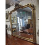 A GEORGIAN STYLE GILT FRAMED OVER MANTEL MIRROR the rectangular moulded frame with canted corners