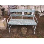 A GEORGIAN STYLE GREEN AND WHITE PAINTED GARDEN BENCH with slat back and seats shaped arms on